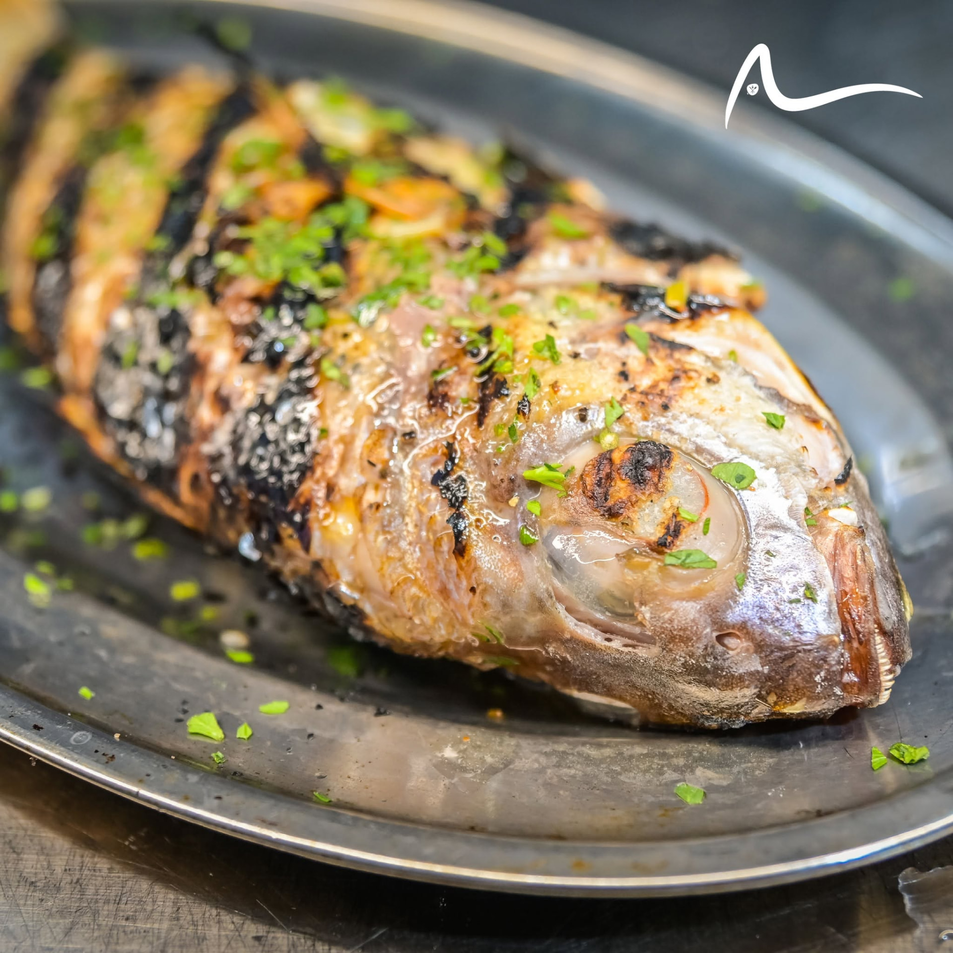 Whole grilled fish with fresh herbs