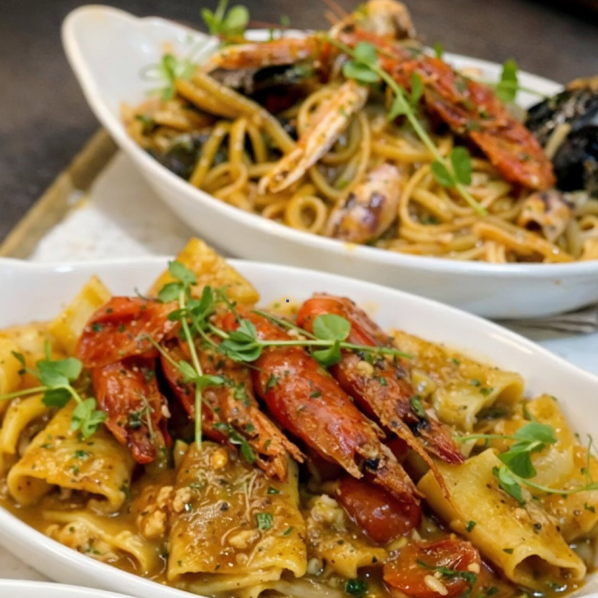 Two plates of Mediterranean shellfish pasta